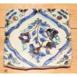 A 17th century Iznik tile, decorated floral spray, 5 1/2" square (some losses to borders)