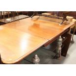 A Victorian mahogany extending dining table with two extra leaves, on turned and castored