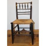 An ebonised frame Sussex chair with string seat