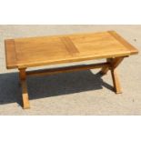 An oak low coffee table, on 'X' frame, 48" long, x 24" wide x 19" high
