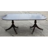 A mahogany and banded double pedestal dining table of Georgian design, 39" wide x 78" long when