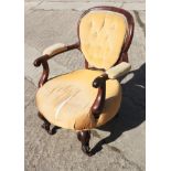 A late 19th century carved rosewood framed open arm low seat occasional chair, on cabriole supports