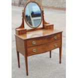 A serpentine front dressing chest of two drawers with jewel drawers over, on square taper