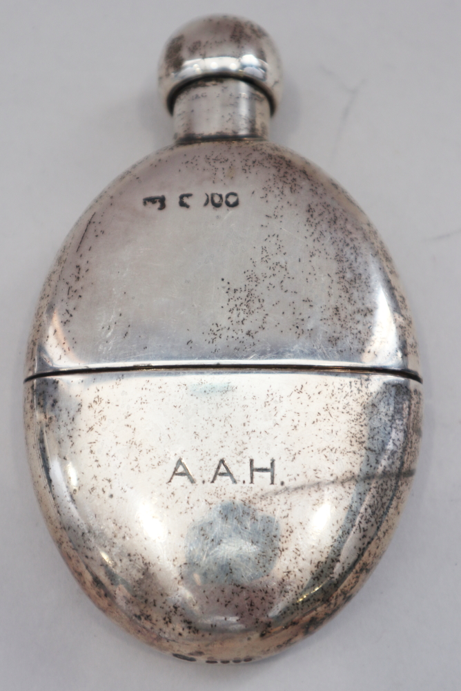 A Victorian silver spirit flask with removable cup and a glass spirit flask with silver cap