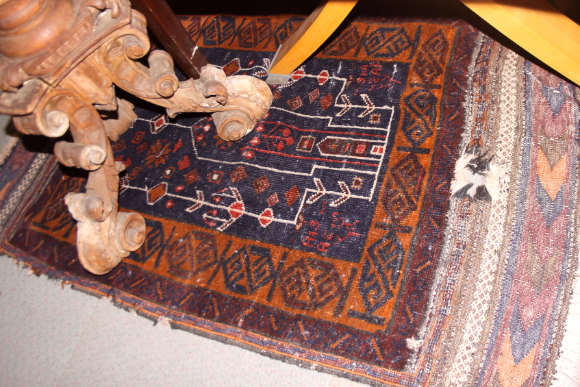 A Persian tribal prayer rug with blue ground, and multi borders in shades of rust red and natural,