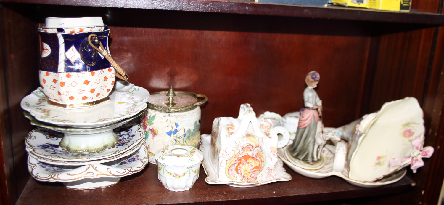 A Payot "Cureville" wall hanging planter, decorated ribbons and flowers, a cheese dish, a biscuit