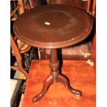 A mahogany circular wine table, on tripod splay supports, 15" dia