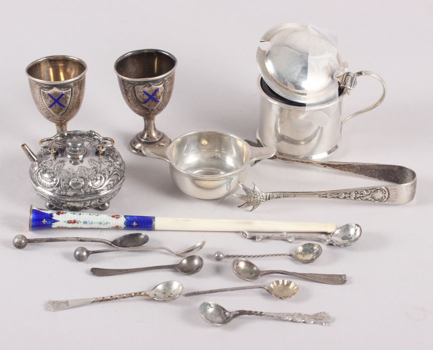 An enamelled cheroot holder, two miniature silver trophy cups, a number of silver condiment spoons