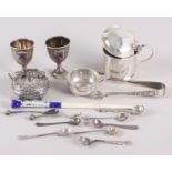 An enamelled cheroot holder, two miniature silver trophy cups, a number of silver condiment spoons