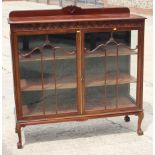 A mahogany bowfront china cabinet, on claw and ball supports, 48" wide x 45" high x 17" deep