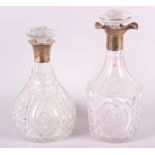 Two cut glass decanters with silver collars