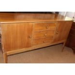 A Gordon Russell 1950s walnut sideboard, fitted three central drawers and flanking cupboards, on