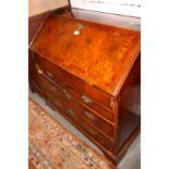 An early Georgian figured walnut and banded fall front bureau, interior fitted drawers,