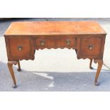 A figured walnut kneehole desk of Queen Anne design, fitted three drawers, on cabriole supports, 46"