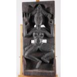 An Indian carved hardwood relief panel of a dancer, 22 1/2" high x 9 3/4" wide