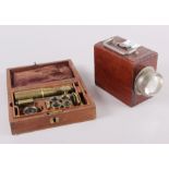 A mahogany cased magnifying set and a signalling light