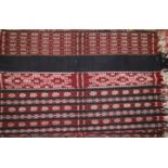 An Ikat panel of multi stripe design in shades of red, blue, natural and yellow, from Savu,