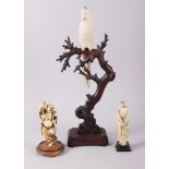 A Chinese carved ivory model of a parrot, on wooden perch, 13 1/2" high overall, and two carved