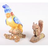 A faience model of a cockatoo, 9 1/2" high, and a model of a squirrel