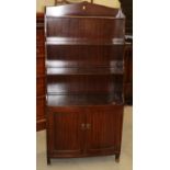 A mahogany bowfront waterfall bookcase over cupboard, 27" wide x 56 1/2" high x 13" deep