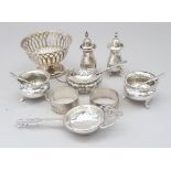 A pierced silver pedestal bonbon dish with weighted base, a pair of silver napkin rings, a silver