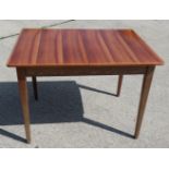 A Gordon Russell 1950s walnut extending dining table with extra leaf, on square taper splay
