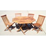 A hardwood slatted octagonal folding garden table and four matching chairs