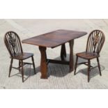 An oak drop leaf dining table, top 31" x 60", and a pair of Windsor wheelback chairs