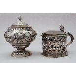 A Victorian octagonal mustard pot with pierced and engraved decoration and a Continental white metal