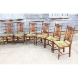 A set of six oak panel back dining chairs with green velvet drop-in seats, on turned and stretchered