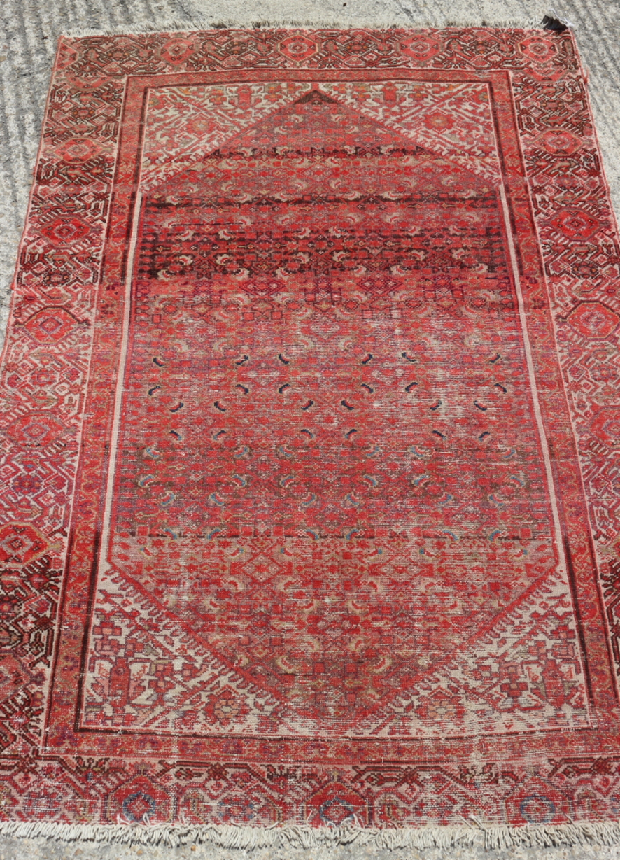 A Turkoman type rug, with all-over geometric design in shades of red, 68" x 50" approx (worn)