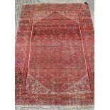 A Turkoman type rug, with all-over geometric design in shades of red, 68" x 50" approx (worn)