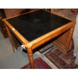 A satin birch and ebony strung bridge table with tooled leather lined top and pull out cup