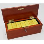 A set of early 20th century Bakelite dominoes, in mahogany case