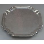 An octagonal silver waiter, raised on four hoof feet, 22.8oz troy approx