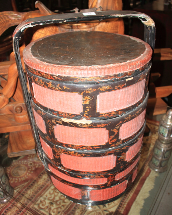 An early 20th century Chinese lacquered and decorated four-section circular (marriage) basket with