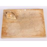 An oak cheese board with carved mouse, attributed to Robert Thompson Mouseman, 9" x 6 1/2"