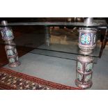 An Indian embossed and enamelled white metal mounted glass two-tier coffee table, 42" square x 19"