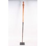 An African/tribal iron mounted spear/stick, the wood handle carved as a female figure, 43" long,