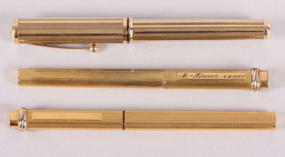 A Shaeffer gold plated fountain pen, a gold plated Cartier ball point pen and a similar felt tip