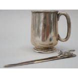 A silver letter opener, decorated with a running fox, and a silver christening mug, 4.3oz troy