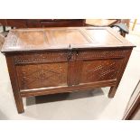 An early 18th century chip carved coffer with triple panel lid, on moulded stile supports (retaining