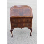 A 1930s walnut fall front bureau, fitted two drawers, on cabriole supports, 27" wide, and two