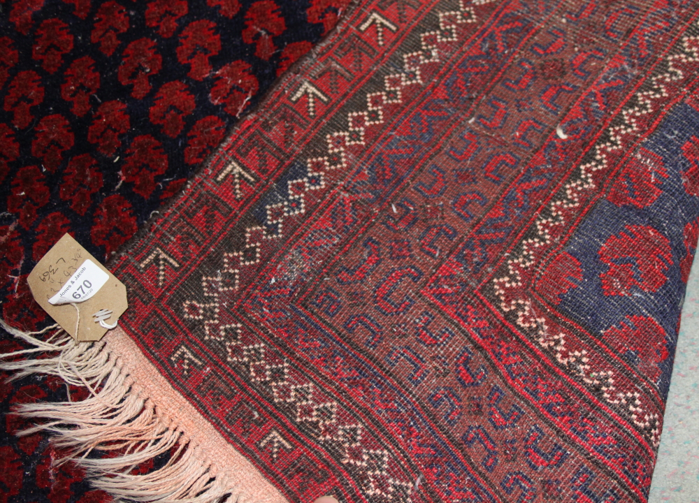 A Middle Eastern geometric design rug on a red ground with multi-borders in shades of blue, 63" x 43 - Image 2 of 2