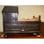 A 19th century chip carved oak cradle of Jacobean design, 39" long x 24" wide x 31" high