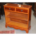 A yew open bookcase, fitted two drawers, on bracket feet, 30" wide x 29" high x 10" deep