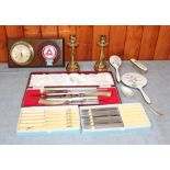 A silver plated and enamelled brush set, a boxed carving set, assorted cutlery and a pair of brass