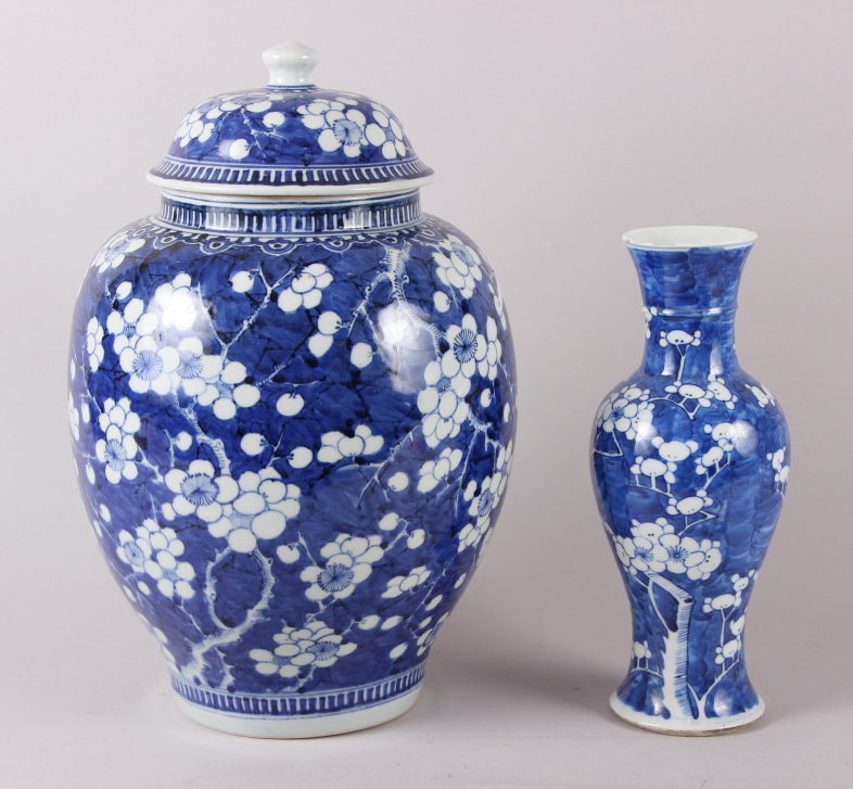 A Chinese blue and white ginger jar and cover, decorated prunus trees, 13 1/2" high, and another