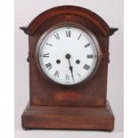 An Edwardian mahogany cased mantel clock with string inlay, white enamel dial and Roman numerals,