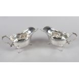 A pair of silver sauce boats with scrolled handles and a pair of Scottish silver sauce ladles, 17.